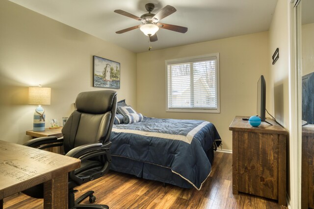 108 Eastbrook Ave, Houghton Lake, MI 48629 - bedroom with wood finished floors, ceiling fan, and baseboards