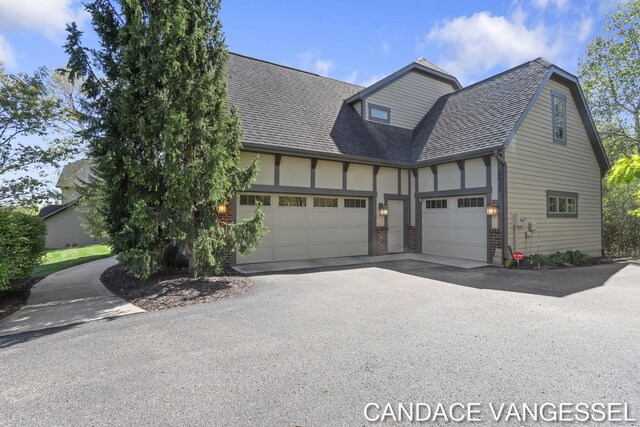 2429 Shears Crossing Ct NE, Grand Rapids, MI 49525 - view of front of property with asphalt driveway, a garage, roof with shingles, and brick siding