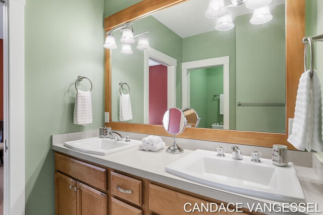 2429 Shears Crossing Ct NE, Grand Rapids, MI 49525 - full bath featuring double vanity and a chandelier