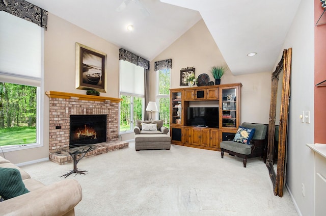 8461 Webster Hills Rd, Dexter, MI 48130 - living room with light carpet, a ceiling fan, a fireplace, baseboards, and high vaulted ceiling