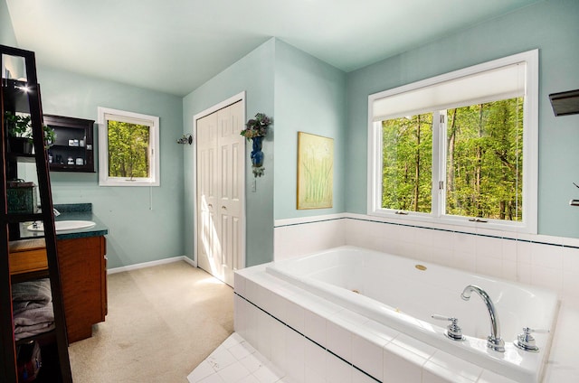 8461 Webster Hills Rd, Dexter, MI 48130 - bathroom featuring plenty of natural light, a garden tub, vanity, and baseboards