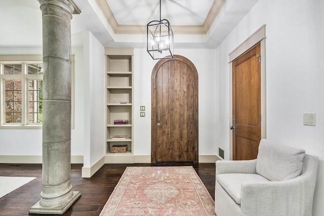 4850 Catamount Trl NE, Ada, MI 49301 - entryway featuring baseboards, crown molding, dark wood-type flooring, decorative columns, and a chandelier