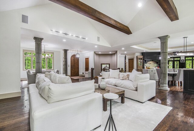 4850 Catamount Trl NE, Ada, MI 49301 - living area with decorative columns, beam ceiling, dark wood-style floors, high vaulted ceiling, and recessed lighting