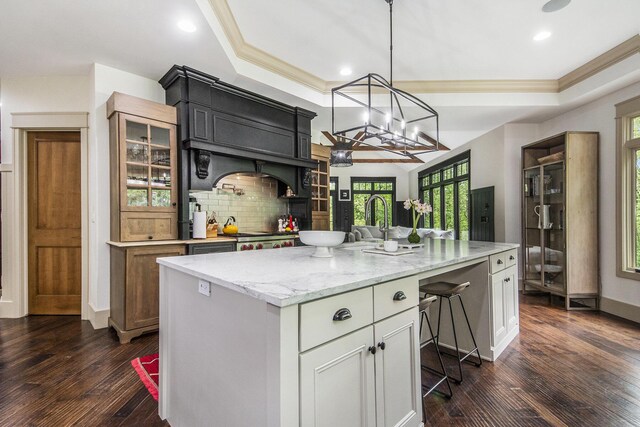 4850 Catamount Trl NE, Ada, MI 49301 - kitchen featuring plenty of natural light, decorative backsplash, glass insert cabinets, ornamental molding, and dark wood-style flooring