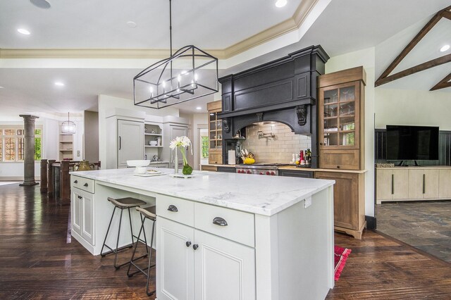 4850 Catamount Trl NE, Ada, MI 49301 - kitchen with light stone counters, glass insert cabinets, dark wood-style floors, recessed lighting, and ornamental molding