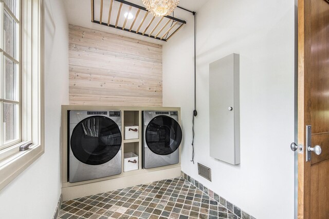4850 Catamount Trl NE, Ada, MI 49301 - washroom with washing machine and dryer and wood walls