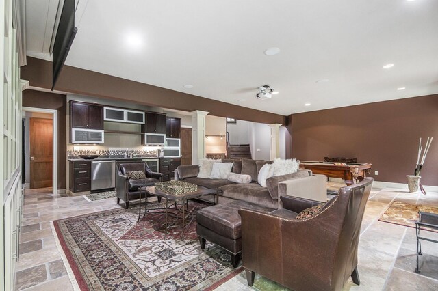 4850 Catamount Trl NE, Ada, MI 49301 - living room with decorative columns, stone tile flooring, and recessed lighting