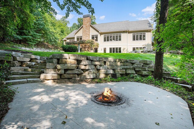 4850 Catamount Trl NE, Ada, MI 49301 - view of patio / terrace with a fire pit