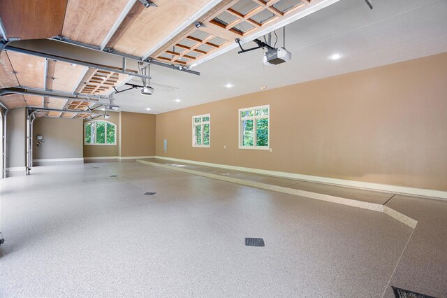 4850 Catamount Trl NE, Ada, MI 49301 - garage with baseboards, a garage door opener, and recessed lighting
