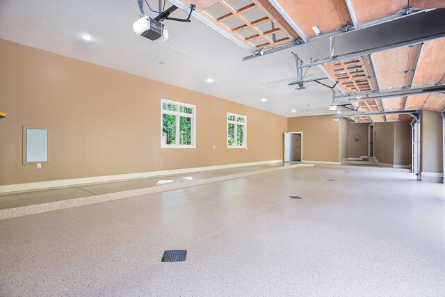 4850 Catamount Trl NE, Ada, MI 49301 - garage with baseboards, a garage door opener, and recessed lighting