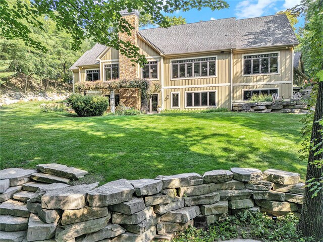 4850 Catamount Trl NE, Ada, MI 49301 - rear view of property featuring a chimney, a lawn, and a shingled roof