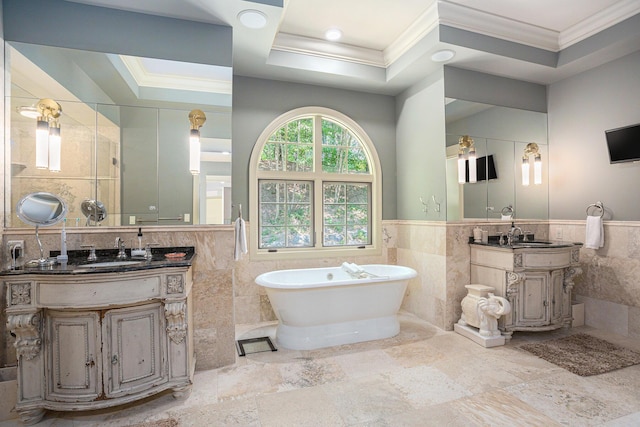 4850 Catamount Trl NE, Ada, MI 49301 - full bath featuring tile walls, crown molding, a soaking tub, two vanities, and a wainscoted wall