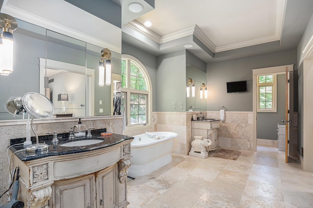 4850 Catamount Trl NE, Ada, MI 49301 - full bath with tile walls, ornamental molding, plenty of natural light, two vanities, and a freestanding bath