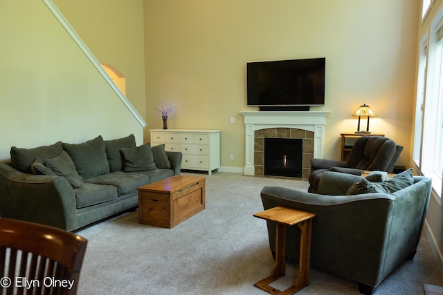 16894 Arbor Way Dr, Nunica, MI 49448 - living room featuring carpet floors, a tiled fireplace, and a towering ceiling