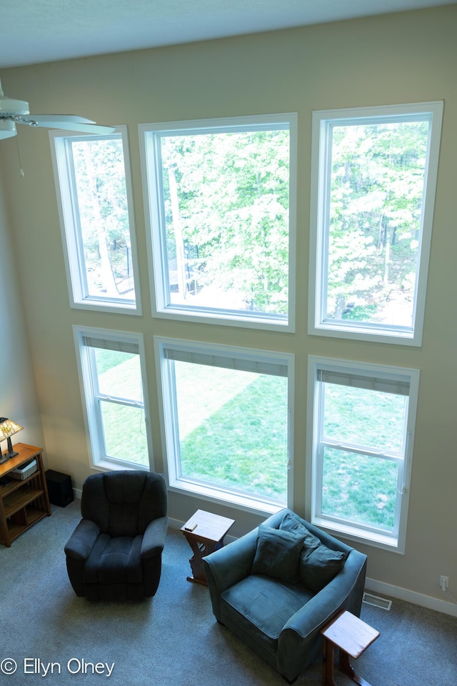 16894 Arbor Way Dr, Nunica, MI 49448 - carpeted living area featuring plenty of natural light, a high ceiling, and ceiling fan
