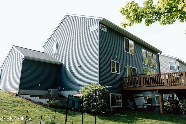 16894 Arbor Way Dr, Nunica, MI 49448 - rear view of house with a deck, a yard, and central air condition unit
