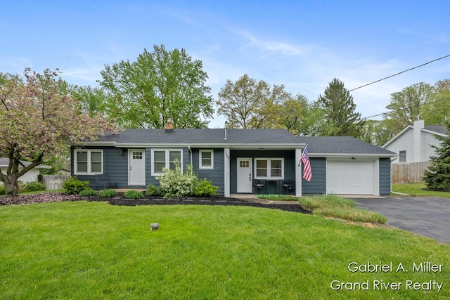 single story home with a garage, asphalt driveway, and a chimney