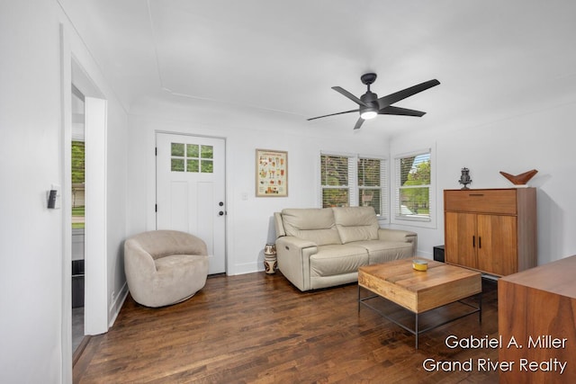 living room featuring healthy amount of natural light, wood finished floors, a ceiling fan, and baseboards