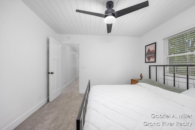bedroom with carpet, baseboards, ceiling fan, and wooden ceiling
