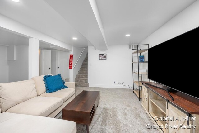 living room featuring carpet floors, stairway, baseboards, and recessed lighting