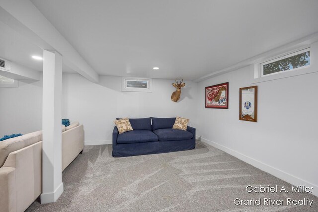 carpeted living area with recessed lighting and baseboards