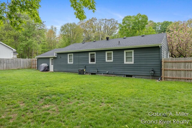 rear view of property with cooling unit