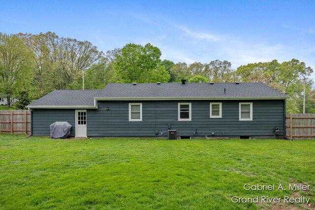 back of property with roof with shingles