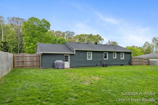 back of property featuring central air condition unit and a shingled roof