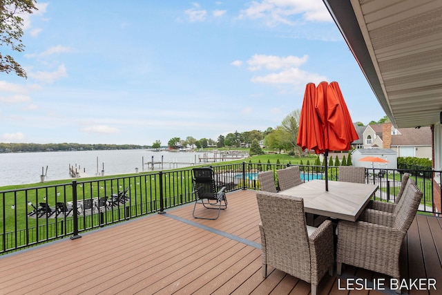 833 Allen Dr, Holland, MI 49423 - wooden terrace featuring a water view, boat lift, a boat dock, outdoor dining area, and a yard