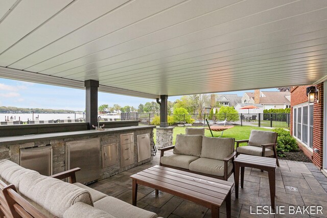 833 Allen Dr, Holland, MI 49423 - view of patio with an outdoor living space and an outdoor kitchen