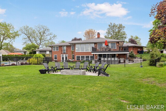 833 Allen Dr, Holland, MI 49423 - back of property featuring an outdoor fire pit, a patio, brick siding, a chimney, and a balcony