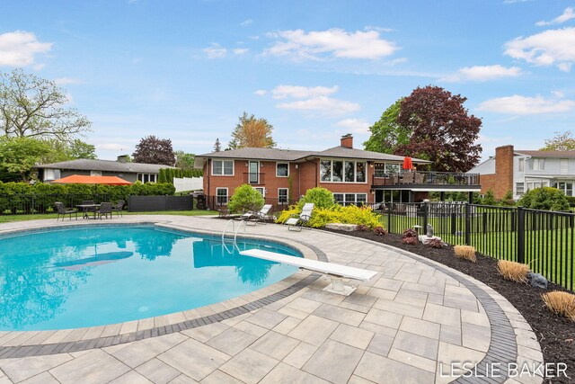 833 Allen Dr, Holland, MI 49423 - view of swimming pool featuring a fenced backyard, a patio, and a diving board