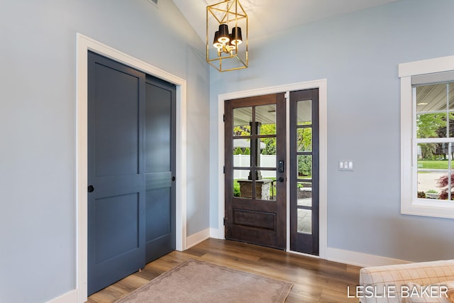 833 Allen Dr, Holland, MI 49423 - foyer entrance with a chandelier, wood finished floors, and baseboards