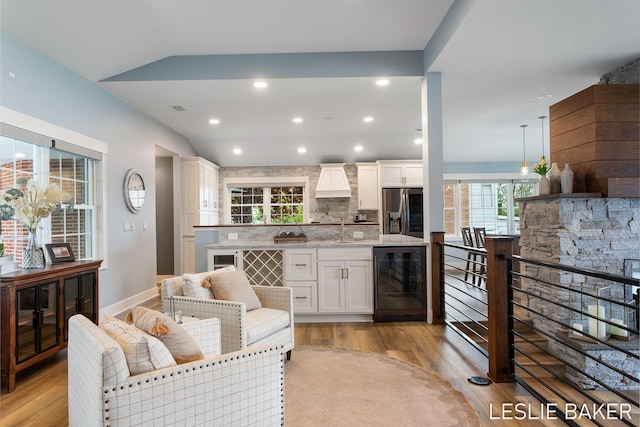 833 Allen Dr, Holland, MI 49423 - living room featuring beverage cooler, light wood-type flooring, recessed lighting, and baseboards