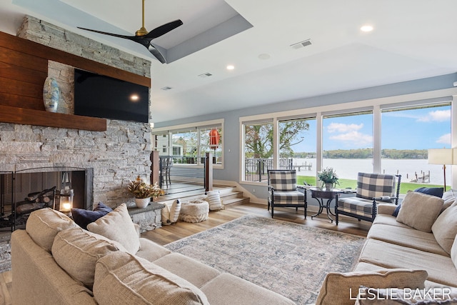 833 Allen Dr, Holland, MI 49423 - living area featuring wood finished floors, lofted ceiling, ceiling fan, a stone fireplace, and recessed lighting