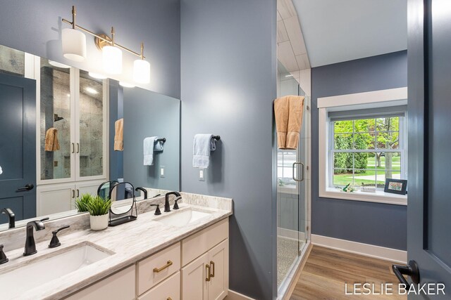 833 Allen Dr, Holland, MI 49423 - bathroom with a shower stall, wood finished floors, baseboards, and double vanity