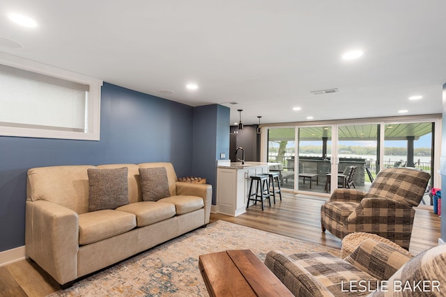 833 Allen Dr, Holland, MI 49423 - living area featuring light wood finished floors, recessed lighting, and baseboards