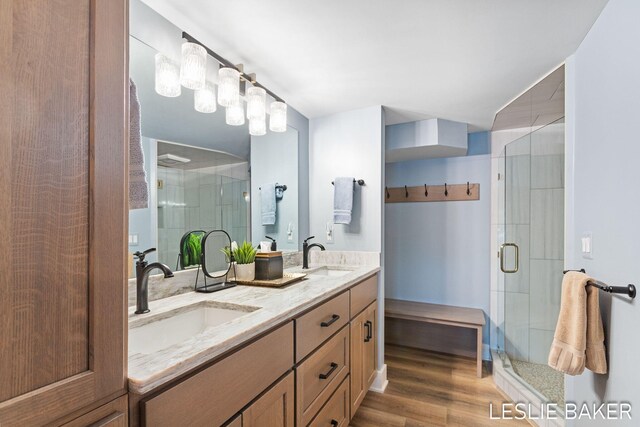 833 Allen Dr, Holland, MI 49423 - bathroom with a stall shower, wood finished floors, and double vanity