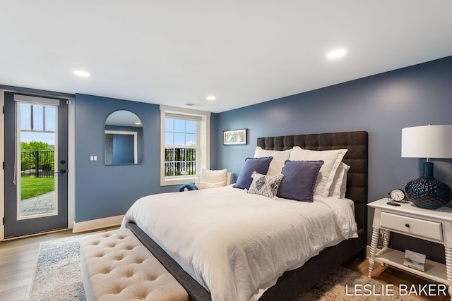 833 Allen Dr, Holland, MI 49423 - bedroom featuring access to outside, wood finished floors, recessed lighting, multiple windows, and baseboards
