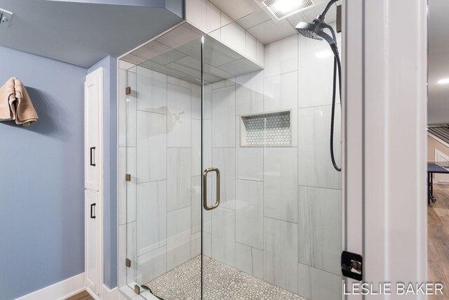 833 Allen Dr, Holland, MI 49423 - full bath with a stall shower, baseboards, and wood finished floors