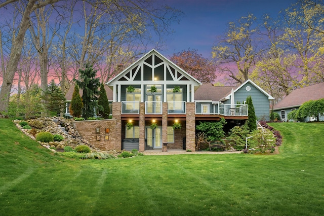 46132 86th Ave, Decatur, MI 49045 - rear view of house featuring a lawn, a wooden deck, and brick siding