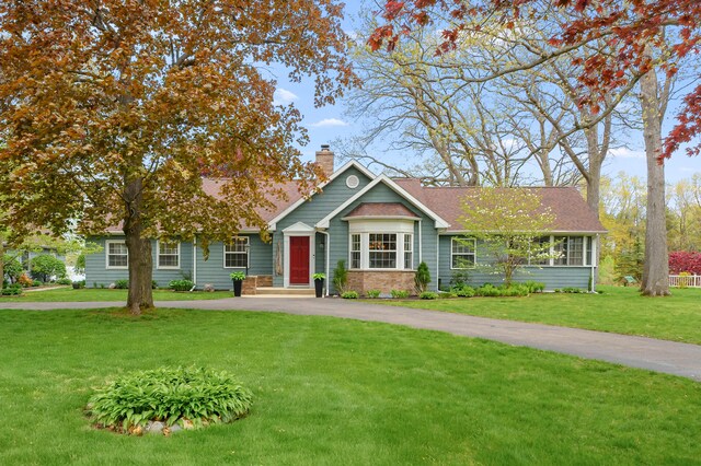 46132 86th Ave, Decatur, MI 49045 - view of front of property featuring a chimney, a front lawn, and asphalt driveway