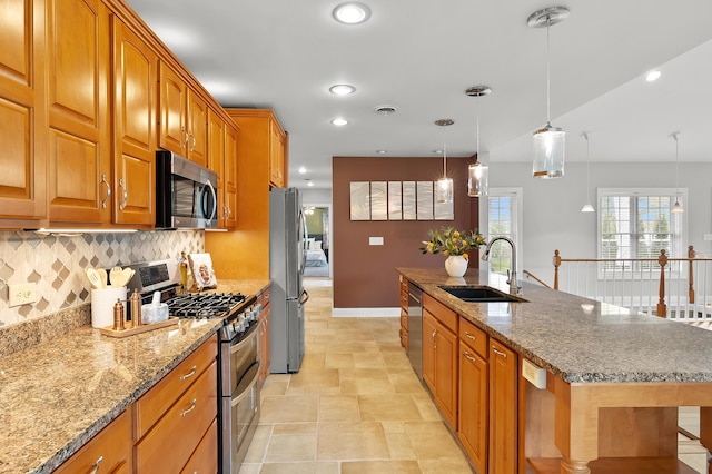 46132 86th Ave, Decatur, MI 49045 - kitchen with appliances with stainless steel finishes, a sink, backsplash, brown cabinetry, and a center island with sink
