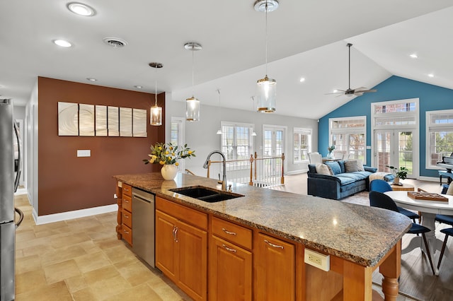 46132 86th Ave, Decatur, MI 49045 - kitchen with a sink, appliances with stainless steel finishes, baseboards, a kitchen island with sink, and light stone counters