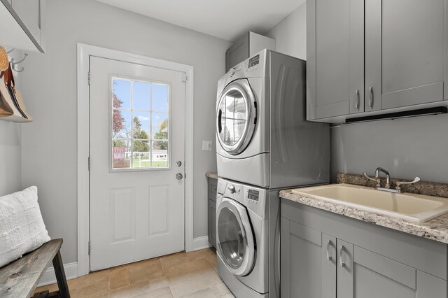 46132 86th Ave, Decatur, MI 49045 - washroom featuring stacked washer / dryer, cabinet space, and baseboards