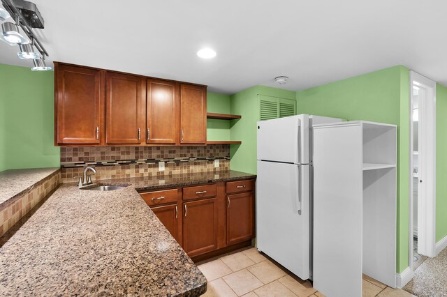 46132 86th Ave, Decatur, MI 49045 - kitchen with a sink, open shelves, freestanding refrigerator, tasteful backsplash, and dark stone counters