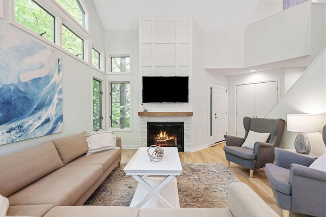 9773 Weko Dr, Bridgman, MI 49106 - living area featuring a high ceiling, a glass covered fireplace, and light wood finished floors