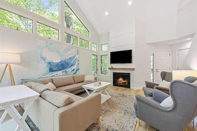 9773 Weko Dr, Bridgman, MI 49106 - living area with high vaulted ceiling, light wood-style floors, a tile fireplace, and recessed lighting