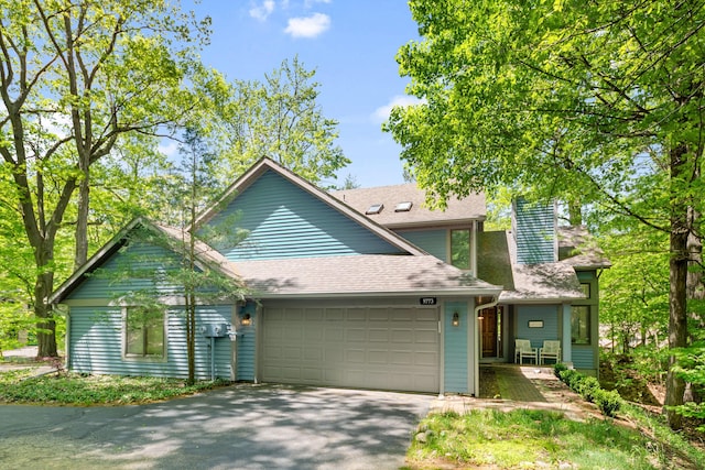 9773 Weko Dr, Bridgman, MI 49106 - view of front of house featuring an attached garage, driveway, and roof with shingles