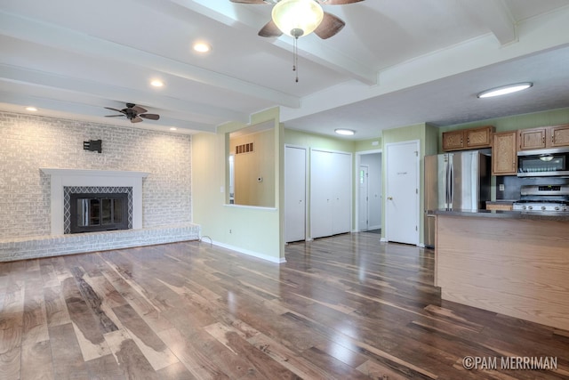8220 Indian Shores Dr, Howard City, MI 49329 - unfurnished living room featuring ceiling fan, beamed ceiling, dark wood-type flooring, a fireplace, and recessed lighting
